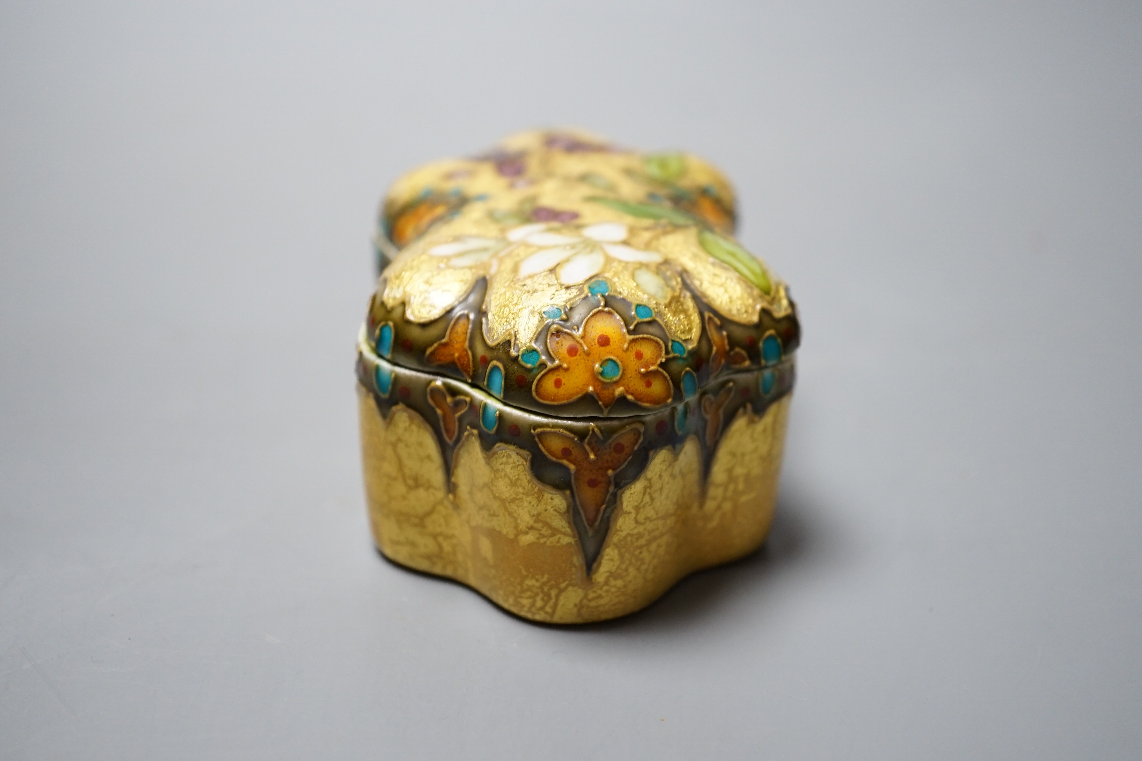 A Clement Massier, Golfe Juan box with enamelled floral decoration on ground yellow base, 9.5cm, original paper labels